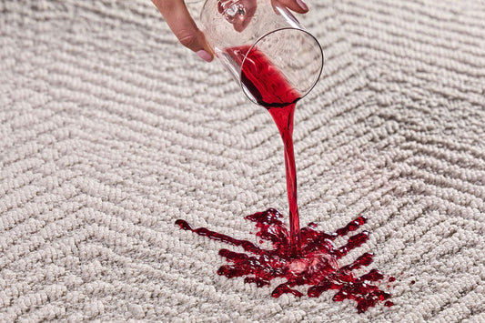 Red wine spilling on Groundstory Elementa spill resistant area rug - stain resistant polypropylene area rug repels spills - best pet friendly rug for high traffic homes